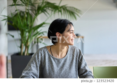 A close up portrait of a young businesswoman engaged in a professional meeting, confidently discussing ideas and strategies with her colleagues A close up portrait of a young businesswoman engaged in a professional meeting, confidently discussing ideas and strategies with her colleagues 123523420