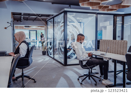 In a modern office setting, an African American businessman and his Muslim colleague, wearing a hijab, engage in collaborative discussions, tackling various business tasks and solving problems In a modern office setting, an African American businessman and his Muslim colleague, wearing a hijab, engage in collaborative discussions, tackling various business tasks and solving problems 123523421
