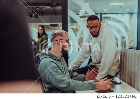 Young group of business people brainstorming together in a startup space, discussing business projects, investments, and solving challenges. Young group of business people brainstorming together in a startup space, discussing business projects, investments, and solving challenges. 123523460