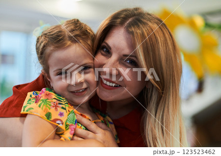 A cute little girl kissing and hugs her mother in preschool 123523462