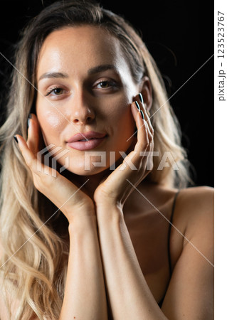 Radiant Elegance: A Stunning Blonde in a Black Dress Exuding Confidence and Beauty. 123523767