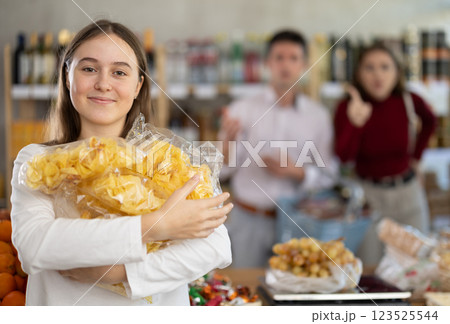 Parents scold girl with chips in grocery store Parents scold girl with chips in grocery store 123525544