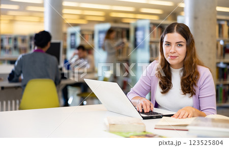 Girl student is studying on a laptop in the library 123525804