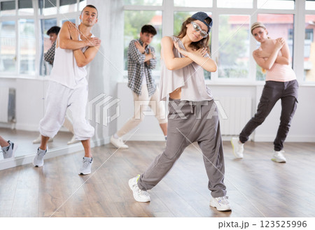 Young girl practicing basic hip hop moves in training hall Young girl practicing basic hip hop moves in training hall 123525996