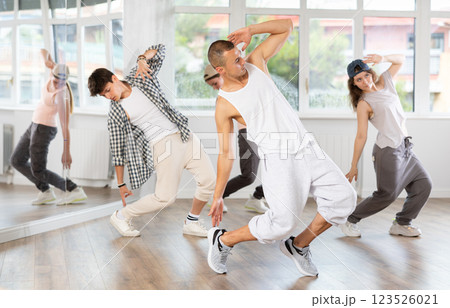Young guy practicing breakdance in training hall 123526021