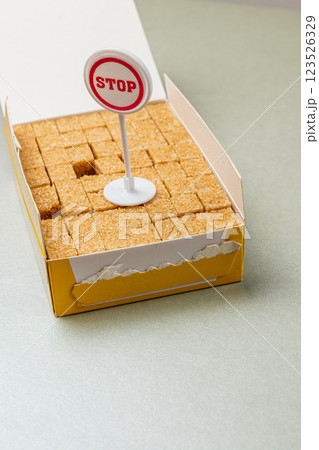 Unique presentation of brown sugar cubes with a stop sign at a cafe 123526329