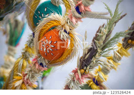 A close-up shows a colorful, handcrafted Polish Easter palm with woolen eggs and dried flora. A close-up shows a colorful, handcrafted Polish Easter palm with woolen eggs and dried flora. 123526424