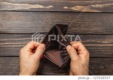 Financial despair leads to an empty wallet reflecting personal crisis Financial despair leads to an empty wallet reflecting personal crisis 123526557