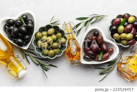 Black, green and kalamata olives with olive oil and olive branches  123529457