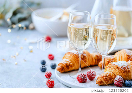 A luxurious morning spread with croissants,berries and champagne, perfect for an indulgent breakfast A luxurious morning spread with croissants,berries and champagne, perfect for an indulgent breakfast 123530202