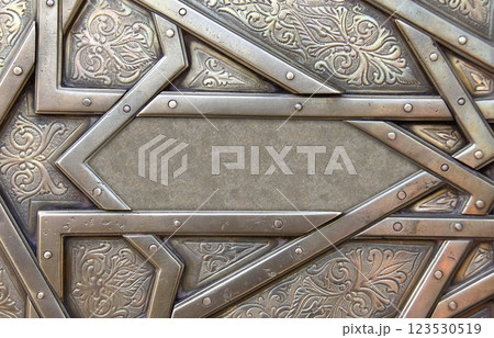 Frame with traditional islamic ornament. Copper window shutter with antique and national moroccan floral pattern. Oriental ornaments with artistic with chasing for brass. Copy space for text 123530519