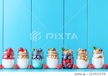 Layered yogurt, berries and granola in mason jars colorful breakfast for on the go 123531579