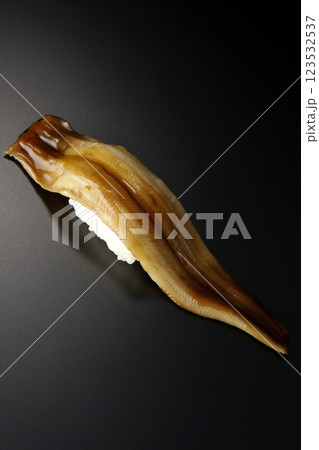 穴子の一本握りを黒背景で撮影 123532537