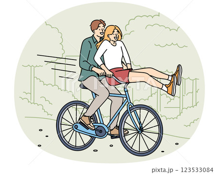 Overjoyed couple ride bike in park Overjoyed couple ride bike in park 123533084