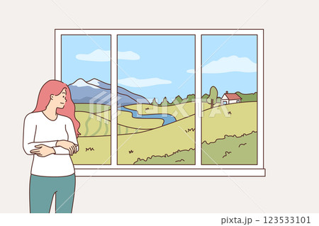 Woman looks out window at landscape and summer nature and smiles, rejoicing at onset of warm weather Woman looks out window at landscape and summer nature and smiles, rejoicing at onset of warm weather 123533101