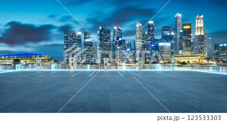 Electric vehicle charging stations illuminating singapore skyline at twilight 123533303