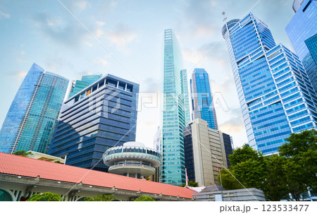 Modern skyscrapers rising above traditional rooftops in singapore's bustling cbd 123533477