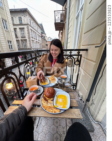 couple Dining on Balcony Overlooking City Street couple Dining on Balcony Overlooking City Street 123533823