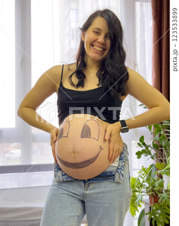 Pregnant Woman with Smiley Face Belly Art 123533899