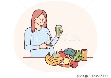 Pregnant woman drinks juice from fresh fruits and vegetables standing near steel with healthy food Pregnant woman drinks juice from fresh fruits and vegetables standing near steel with healthy food 123534147