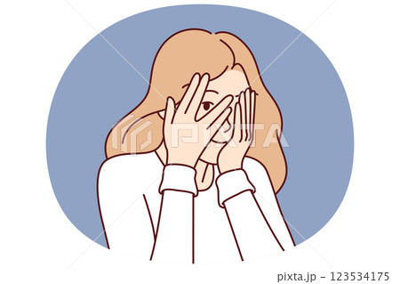Woman covers eyes with hands and peeps, refusing to see unpleasant things and hiding from problems Woman covers eyes with hands and peeps, refusing to see unpleasant things and hiding from problems 123534175