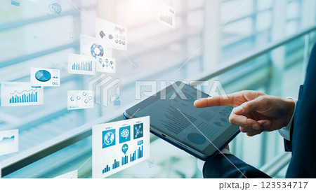 タブレットを使うビジネスマンと電子書類のイメージ タブレットを使うビジネスマンと電子書類のイメージ 123534717