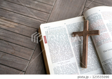 Wooden crucifix cross on top of an open Holy Bible. Wooden crucifix cross on top of an open Holy Bible. 123535090