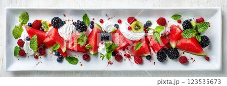 Vibrant summer fruit salad featuring watermelon and berries on a white plate 123535673