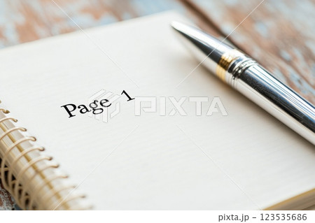 Minimalist design of an empty notebook with the words Page 1 and a silver pen beside it 123535686
