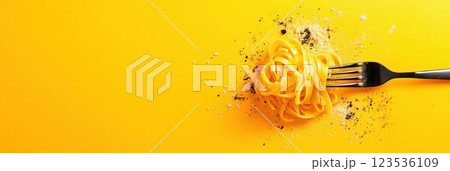 Mid air capture of pasta strands twirling with a fork against a bright sunny backdrop 123536109