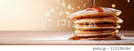 Flying pancakes stacked high with syrup pouring down in a bright and playful arrangement 123536164