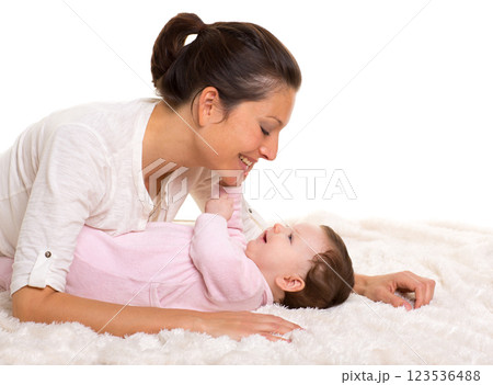 Baby girl and mother lying happy playing together Baby girl and mother lying happy playing together 123536488