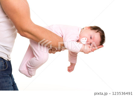 almost sleeping baby girl in father arms on white almost sleeping baby girl in father arms on white 123536491