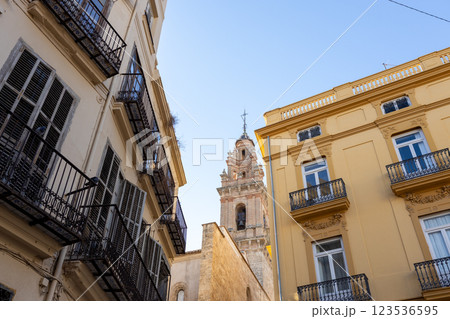 Exterior facade, with many windows, balconies, glass doors. Old house wall. Architecture on an urban historic street of Valencia, Europe. 123536595