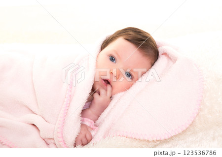 baby girl with toothache in pink with white fur 123536786