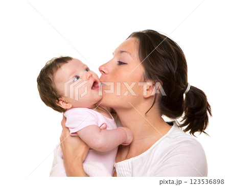 Beautiful mother kissing baby girl hug on white Beautiful mother kissing baby girl hug on white 123536898