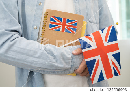 Learn English language, Asian teenage student hold book with flag in course at school. 123536908