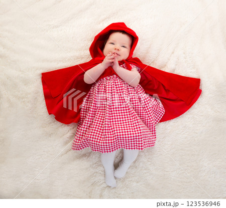 Baby Little Red Riding Hood on white fur 123536946