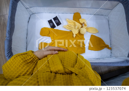Cozy Baby Crib with Yellow Outfit and Accessories Cozy Baby Crib with Yellow Outfit and Accessories 123537074