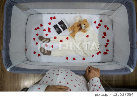 Baby Outfit with Teddy Bear in Crib Baby Outfit with Teddy Bear in Crib 123537084