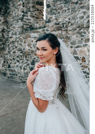 Stunning bride in a snow-white wedding dress with short sleeves. Stunning bride in a snow-white wedding dress with short sleeves. 123538084