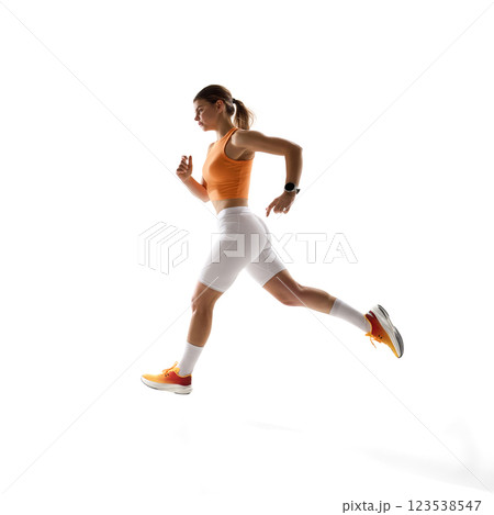 Motivated female runner mid-motion, running forward, embodying athletic excellence against white studio background. Motivated female runner mid-motion, running forward, embodying athletic excellence against white studio background. 123538547