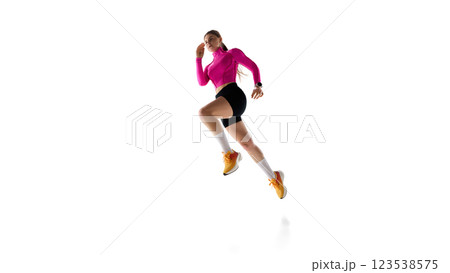 Dynamic image of female athlete sprinting, growing speed and endurance, training against white studio background. 123538575