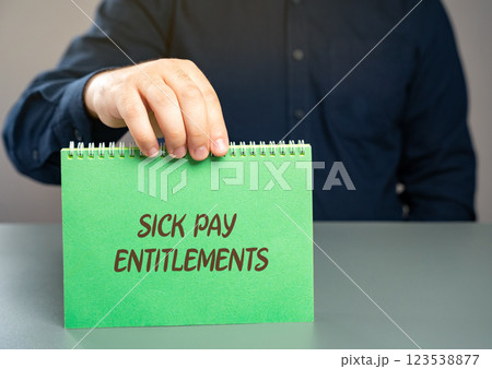 Sick pay entitlements concept. Right of employees to receive compensation from their employer or a government program while they are unable to work due to illness or injury. Notepad in the hands 123538877