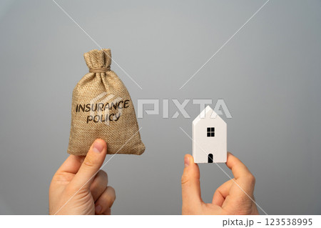 Money bag with Insurance policy and house. In real estate refers to various types of coverage that protect property owners, investors, and businesses from financial loss related to real estate assets Money bag with Insurance policy and house. In real estate refers to various types of coverage that protect property owners, investors, and businesses from financial loss related to real estate assets 123538995