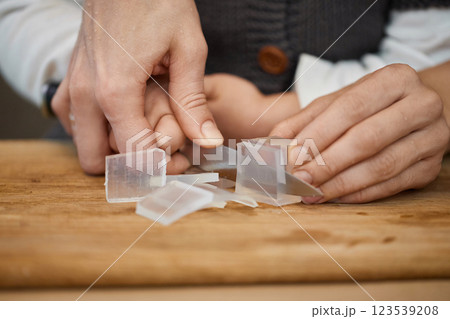 close-up, mother helps her little child girl using knife for preparing hand-made soap, art workshops for children. 123539208