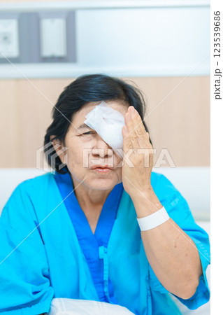 Elderly Woman with eye protective shield after eye surgery. Eye disease, Cataract,  Glaucoma, Age Related Macular Degeneration, Diabetic Retinopathy, Vitreous, Lasik, World Glaucoma day and health 123539686