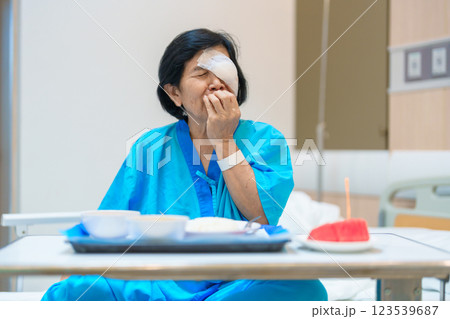 Senior Woman eating food after eye surgery in hospital . Eye disease, Cataract,  Glaucoma, Age Related Macular Degeneration, Diabetic Retinopathy, Lasik, World Glaucoma day and health treatment 123539687