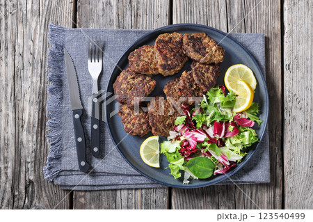 pork liver patties with fresh salad and lemon pork liver patties with fresh salad and lemon 123540499