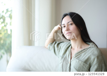 Serious asian woman posing at home looking at you Serious asian woman posing at home looking at you 123541329